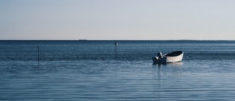 Wide panorama of the Hagensche Wiek bay on Rügen in evening light.